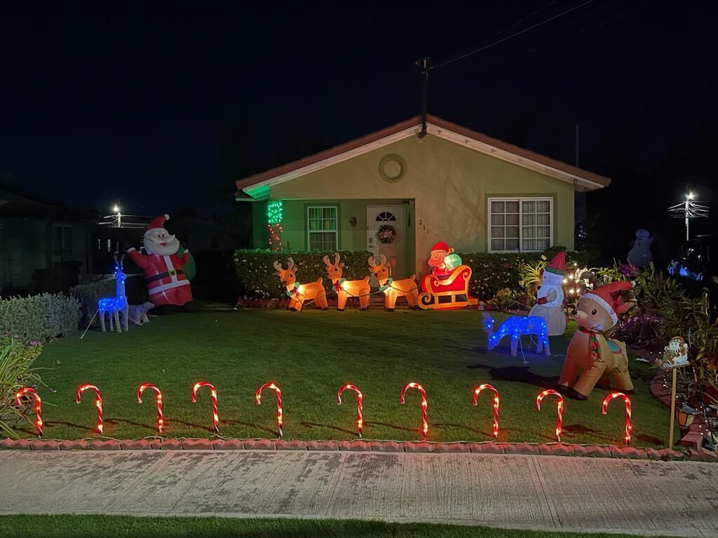 A house with a well-maintained lawn, a front porch, and a small garage.