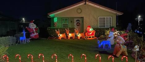 A house with a well-maintained lawn, a front porch, and a small garage.