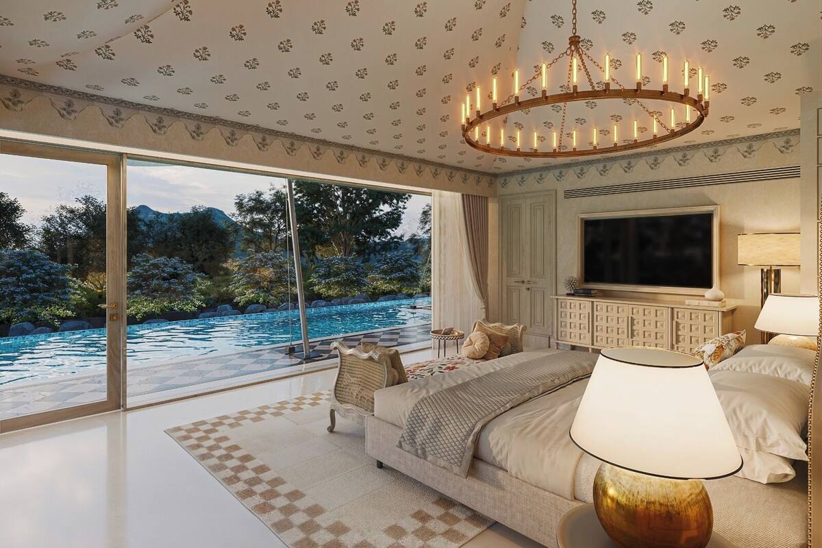 A bedroom with a large TV, a chandelier, and a view of a pool and garden.