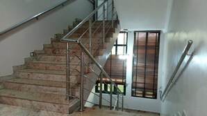 A staircase with metal railings and marble steps. - Dionzec Hotel & Suites (Lagos)