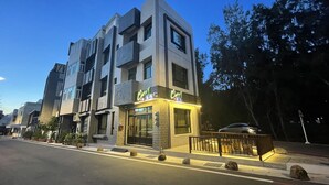 A modern multi-story building with a storefront named 'Chem'. - Cherry Inn (Magong)