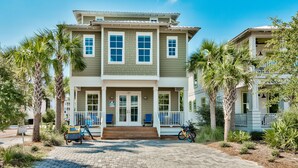 A two-story house with a porch, a front door, and a mailbox. - New construction, custom decorated, chic and spacious Seacrest home, sleeps 14 (Rosemary Beach)