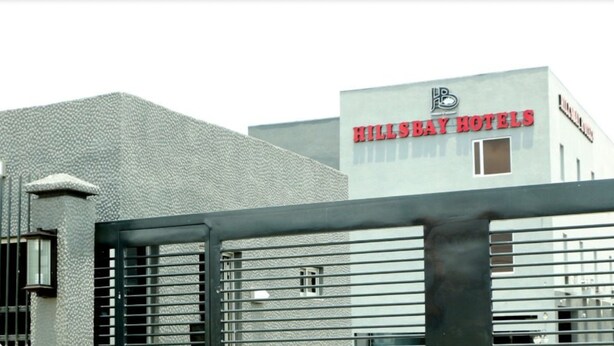 A building with a textured facade and a sign for Hillsbay Hotels. - Hillsbay Hotels (Lekki)