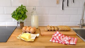A kitchen counter with eggs, butter, bread, a plant, and a milk bottle. - The Stay Las Palmas (Las Palmas de Gran Canaria)