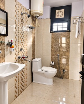 A bathroom with a toilet, bidet, and sink. - Hill View Homes (Nainital)