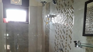 A bathroom with a toilet, bidet, sink, and a shower area. - Hill View Homes (Nainital)
