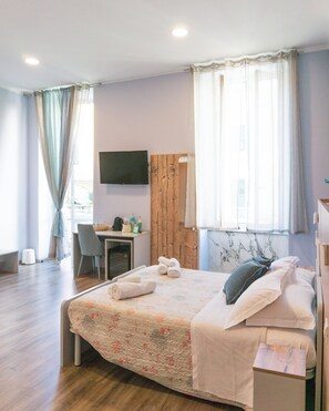 Habitación cuádruple Confort | Minibar, caja de seguridad en la habitación y escritorio 