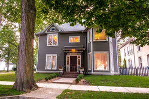 A two-story house with a front porch, large windows, and a tree in front. - Valparaiso Inn Bed & Breakfast (Valparaiso)
