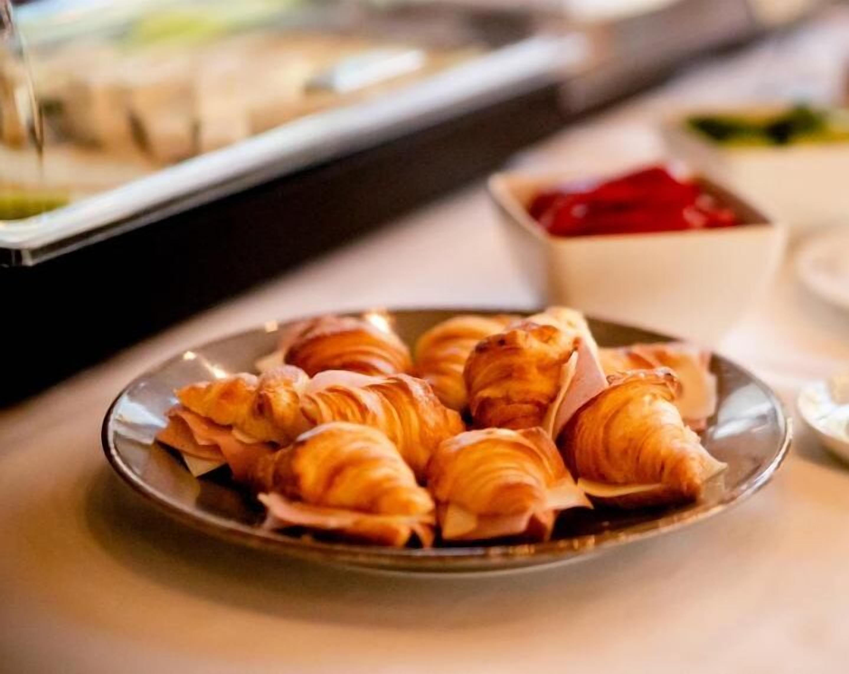 Et fad med croissanter på et bord.