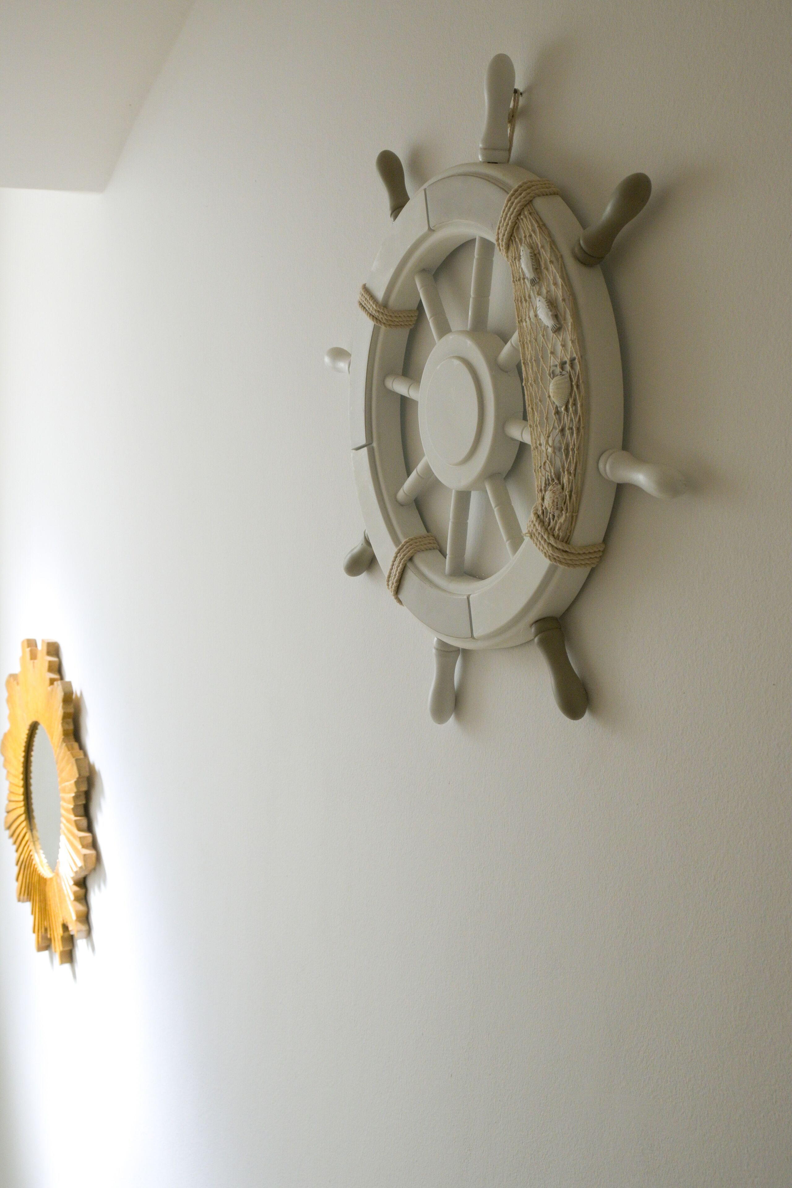A wall-mounted ship's wheel decoration.