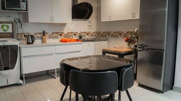 Full-size fridge, microwave, stovetop, cookware/dishes/utensils