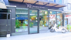 A storefront with a sign reading "The 92 Residence & Coffee." - The 92 residence (Bangkok)