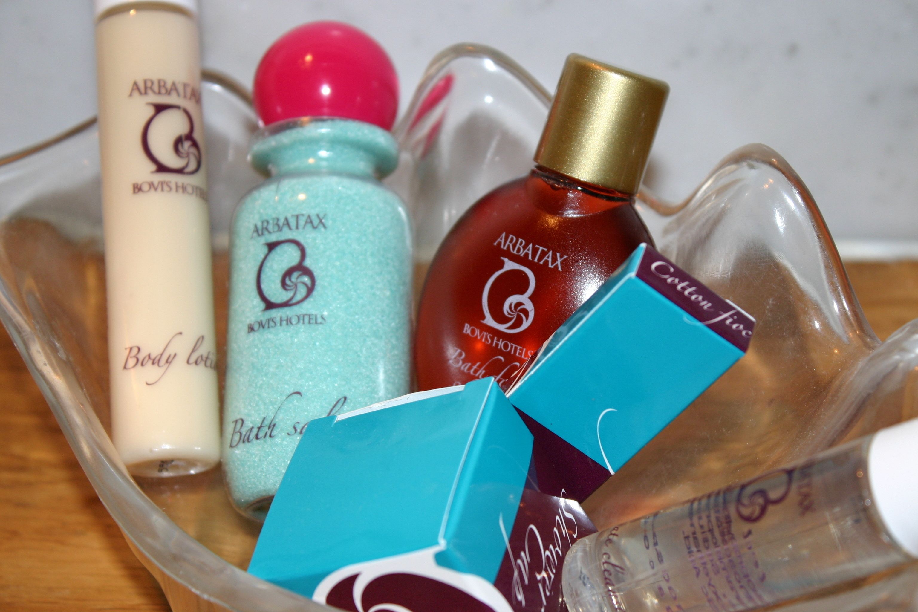 Toiletartikelen zoals bodylotion, badzout en een fles badgel.