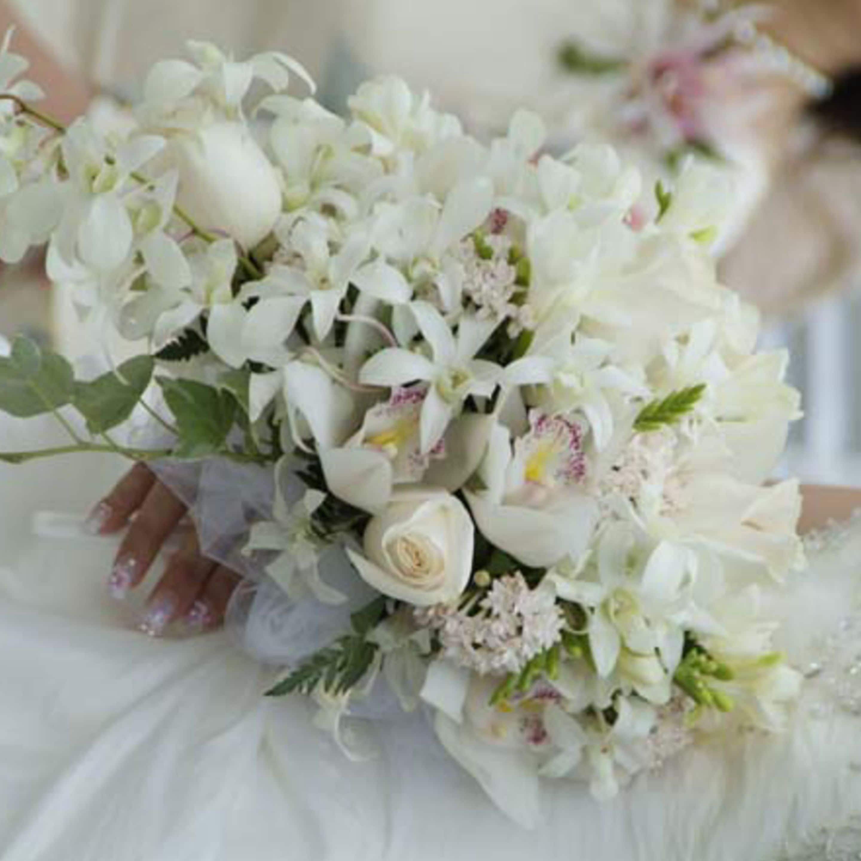 A bouquet of white flowers and a single rose.