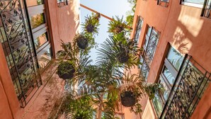 A multi-level atrium with hanging plants and wrought iron balconies. - Hotel Santa Catalina By OxoHotel (Cartagena)