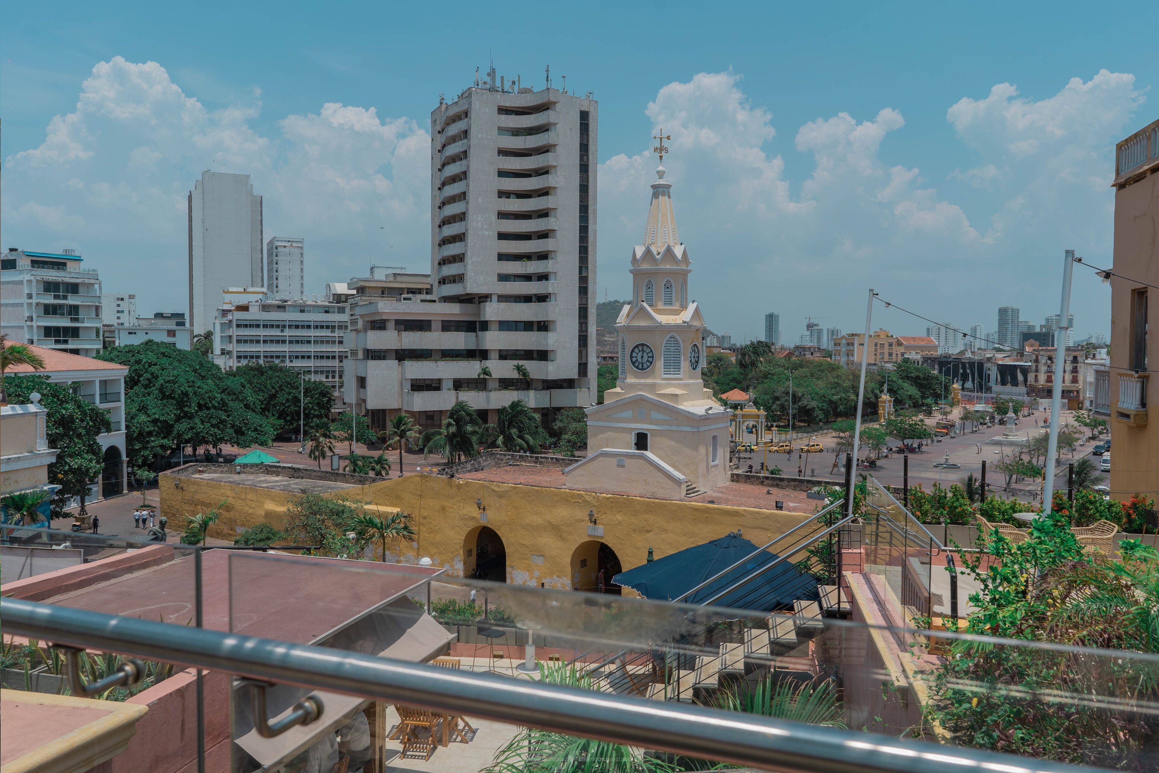 A cityscape with a prominent clock tower and a tall building.
