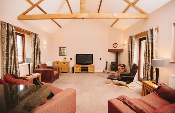 Cottage, Multiple Beds | Living area | 50-inch TV with digital channels, DVD player