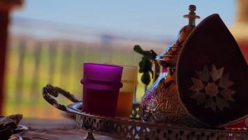A tray with a teapot, a cup, and a decorative plate.