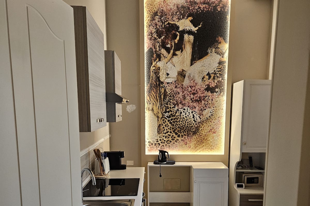 A modern kitchen with a built-in microwave, a sink, and a countertop.