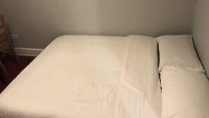 A single bed with white bedding in a room with light gray walls. - Rooms at 5 Hammersmith Road - Hostel (London)
