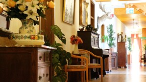 A room with wooden furniture, a piano, and framed pictures on the wall. - Hotel Werneths Landgasthof Hirschen (Rheinhausen)