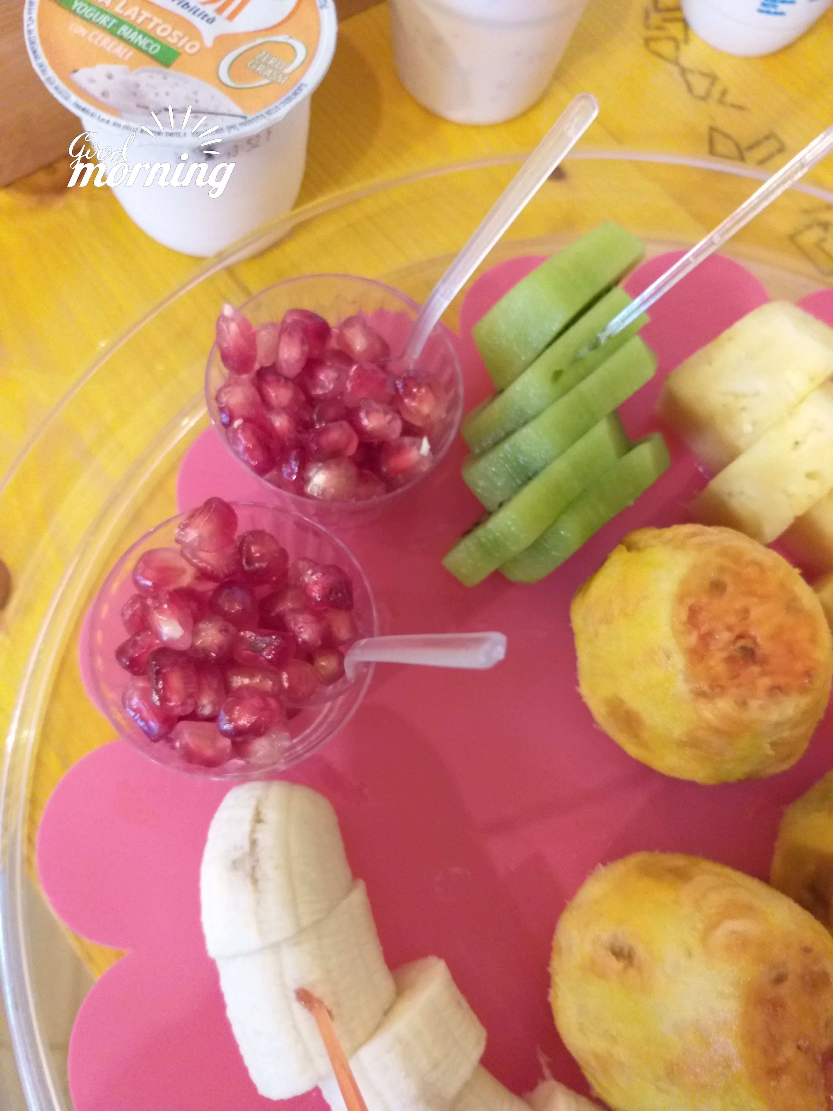 Bandeja de desayuno con semillas de granada, pepinos en rodajas, rodajas de plátano y galletas.