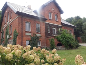 A large brick building with multiple windows and a prominent entrance.