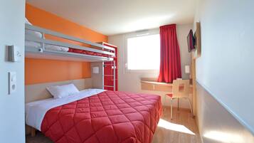 A bunk bed room with a red bedspread, a desk, and a chair.