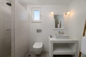 A modern bathroom with a toilet, sink, and shower. - Stegna Akti (Rhodes)