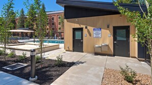 A building with a pool, outdoor seating, and a sign indicating personal hygiene facilities. - Main Street/Town Lift, Pool, Hot Tubs, Location, Comfort, Value, A/C, Fireplace (Park City)