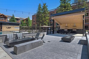 A rooftop patio with outdoor seating, a fire pit, and string lights. - Main Street/Town Lift Access | Comfort | Value | Pool | Hot Tubs | Wifi | A/C  (Park City)