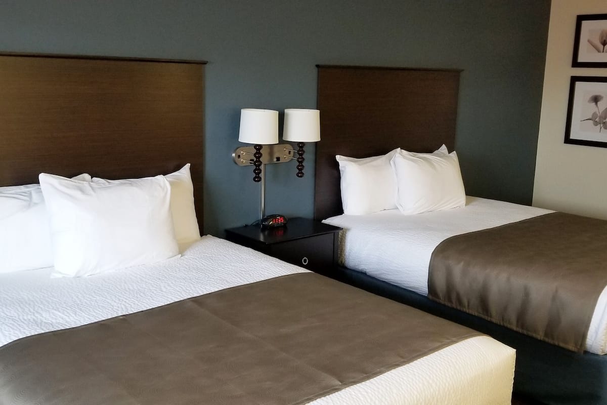 pillow-top beds, desk, laptop workspace, blackout curtains