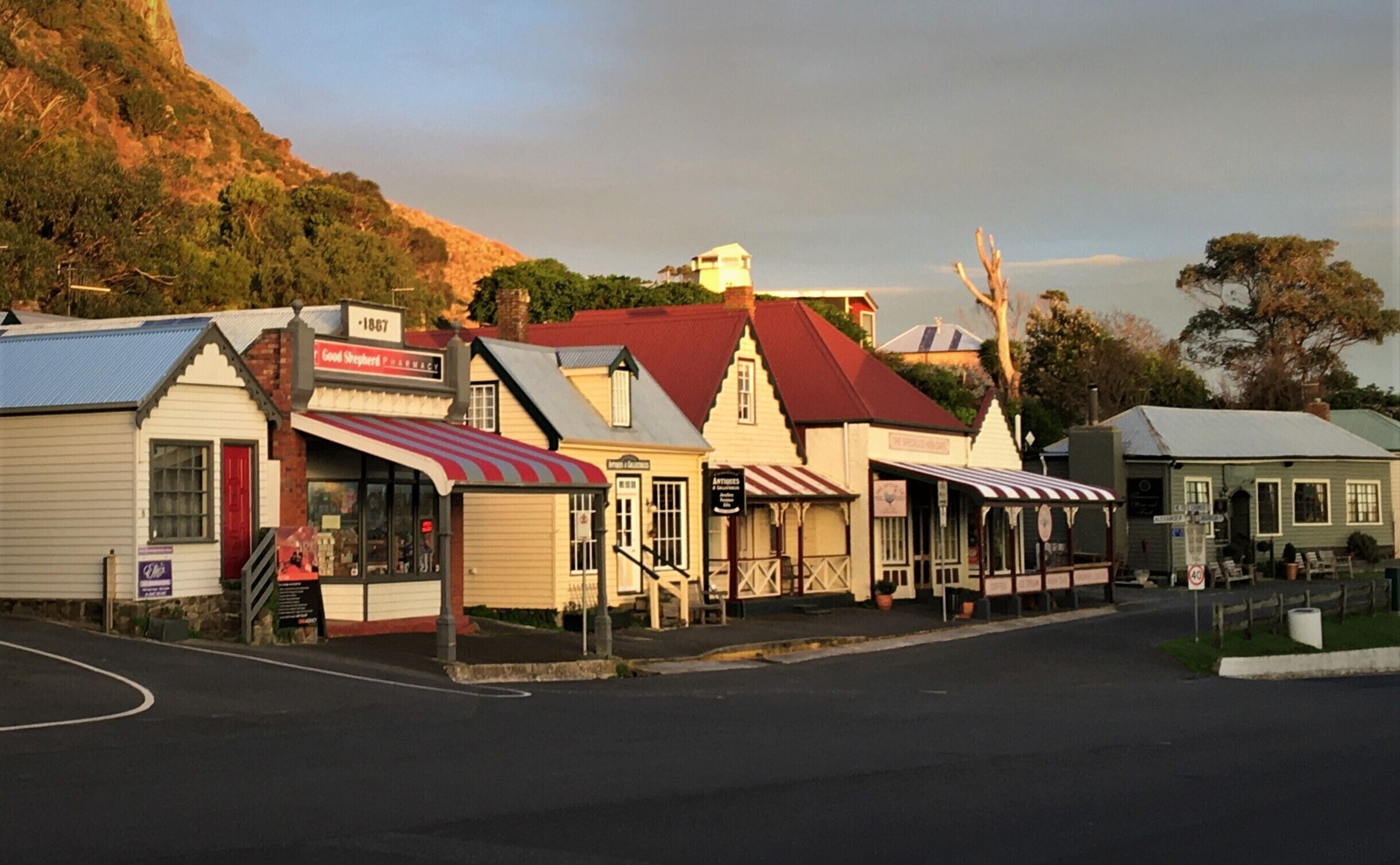 A row of historic buildings with a pharmacy, a butcher shop, and a general store.