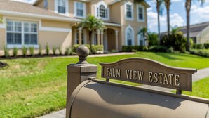 A beige mailbox with "PALM VIEW ESTATE" sign. - Large outdoor summer kitchen, Private Pool, Theatre Room, 2 miles to Disney ! (Kissimmee)