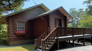A log cabin with a wooden deck and a staircase leading to the entrance. - Mtn.View from Hottub, A+ Location 2 Mi to PF.Pkwy,Not up Mtn,Private,SUPERCLEAN (Sevierville)