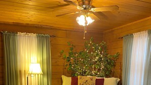 A wooden-paneled room with a bed, a chair, a lamp, and a ceiling fan. - Mtn.View from Hottub, A+ Location 2 Mi to PF.Pkwy,Not up Mtn,Private,SUPERCLEAN (Sevierville)