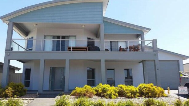 A two-story building with a balcony on the upper floor.