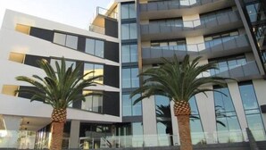 Un edificio moderno a più piani con ampie finestre e balconi.