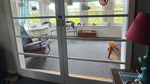 A room with a sliding glass door leading to an outdoor seating area.