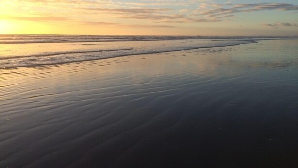 A beach with calm waters and a sunset. - Rose Cottage get-away, Foxton Beach (Foxton Beach)
