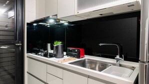 A modern kitchen with a built-in microwave, a toaster, and a sink. - Modern Building in City Center 3/2bath across Taipei Main Station (Taipei City)