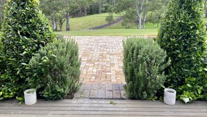 A paved pathway leading to a grassy area with trees in the background. - Marden Meadows - Luxury home in Kangaroo Valley (Kangaroo Valley)