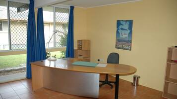 Work in comfort with a desk and chair, plus a large window for natural light.