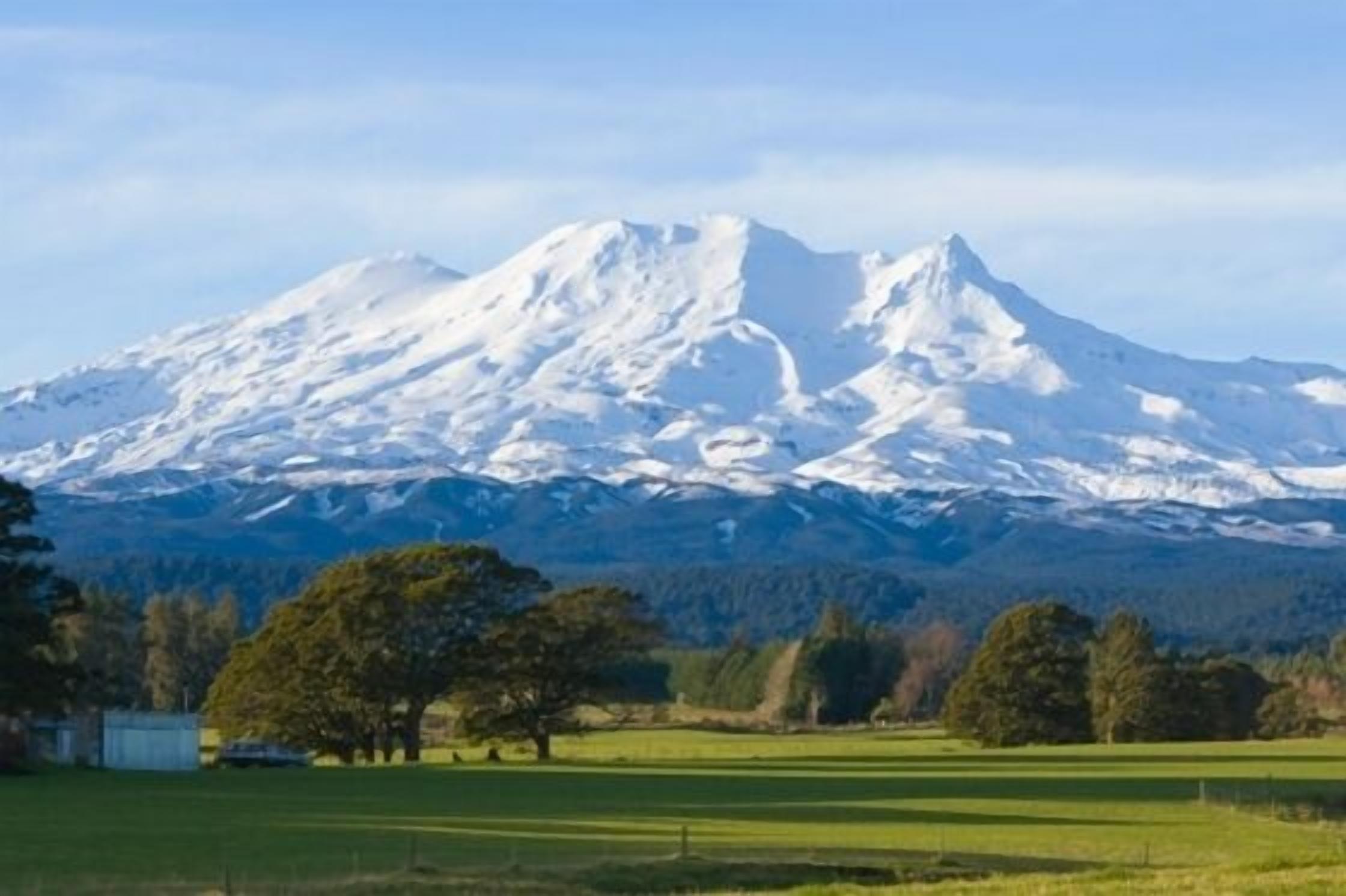 A snow-covered mountain with a clear sky.