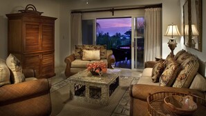 A living room with a sofa, armchairs, a coffee table, and a cabinet. - Los Suenos Marina and Resort - Del Mar Luxury Condo 3 Br/2 Ba (Herradurra Beach Jaco)