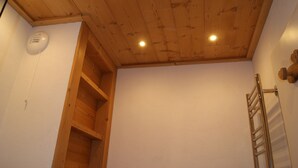 A room with a wooden ceiling, a white wall, and a metal towel rack. - fantastic location, 3 minutes walk to piste & village - sleeps 8, wifi & views! (RA)