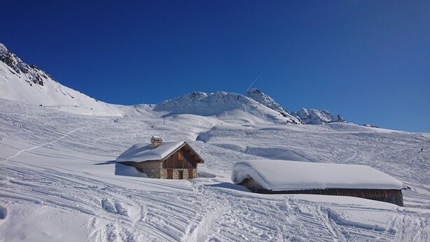 A snow-covered mountain with a wooden cabin and a snow-covered structure. - fantastic location, 3 minutes walk to piste & village - sleeps 8, wifi & views! (RA)