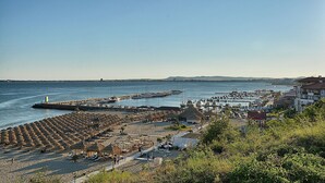 A coastal area with a beach, a pier, and buildings. - Luxury Penthouse Apartment with Panoramic Sea Views (Sveti Vlas)
