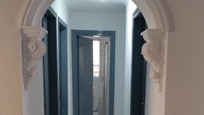 A hallway with a white marble floor, leading to a bathroom with a toilet and a shower. - Disabled friendly - LUXURY bungalow / Villa , San Eugenio,  Costa Adeje  (Costa Adeje)