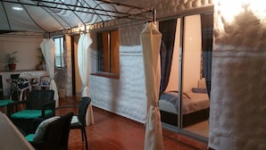A room with a bed, a window, a chair, and a table. - Disabled friendly - LUXURY bungalow / Villa , San Eugenio,  Costa Adeje  (Costa Adeje)